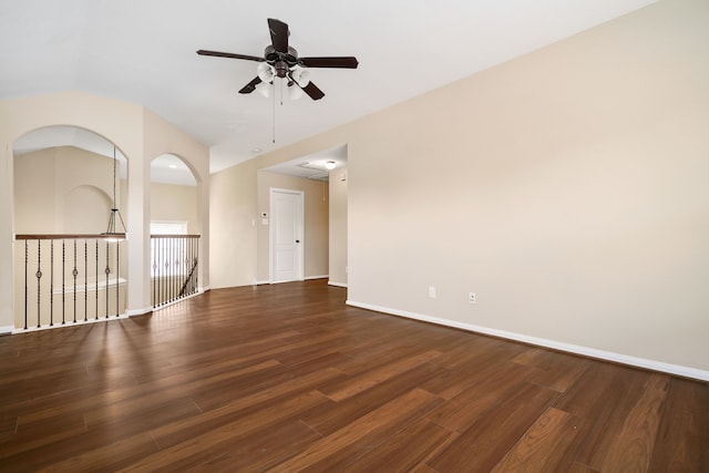 empty room featuring a ceiling fan, baseboards, and wood finished floors