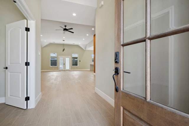 foyer with recessed lighting, ceiling fan, vaulted ceiling, light wood-type flooring, and baseboards