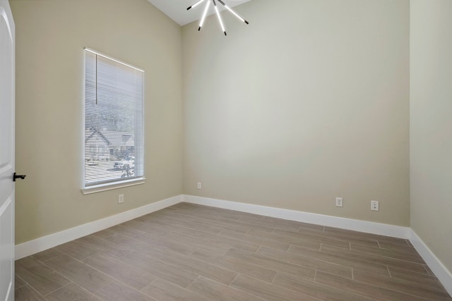 unfurnished room featuring baseboards and wood finished floors