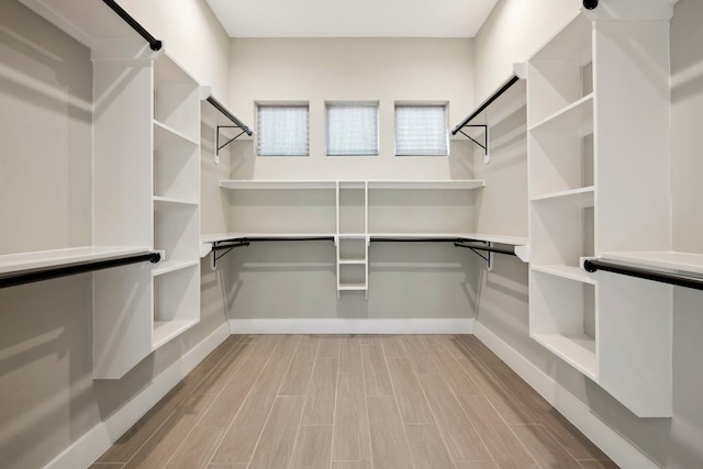 walk in closet featuring wood finish floors