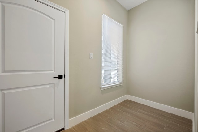 unfurnished room featuring light wood finished floors and baseboards