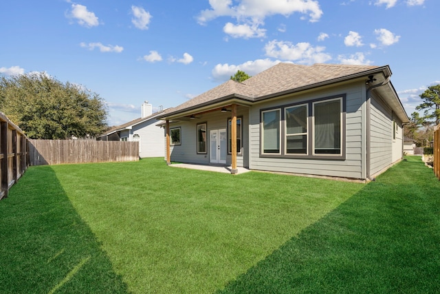 back of house featuring a patio, a lawn, a fenced backyard, and a ceiling fan