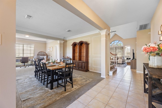 dining area with light tile patterned floors, plenty of natural light, visible vents, and ornate columns