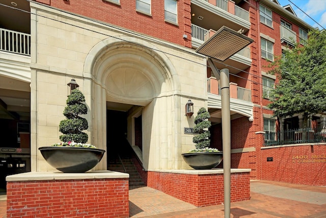 property entrance featuring stone siding and brick siding