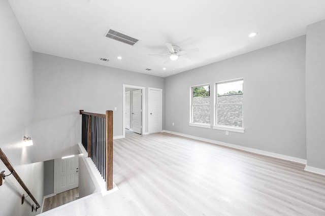 interior space featuring baseboards, visible vents, light wood-style flooring, and recessed lighting