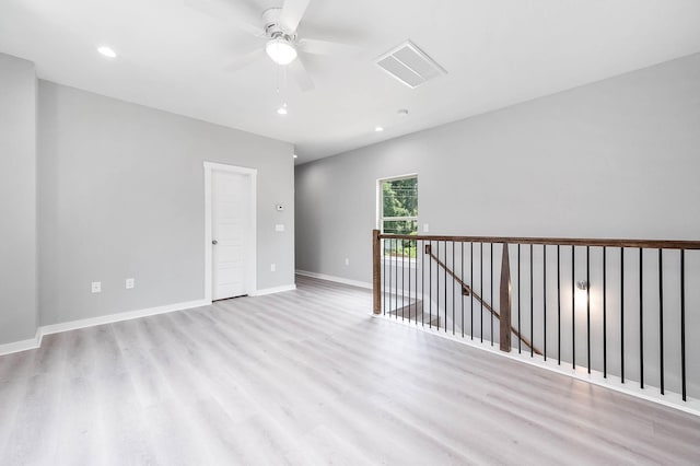 unfurnished room with light wood finished floors, visible vents, baseboards, and recessed lighting