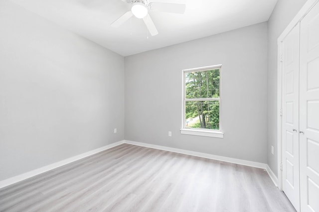 unfurnished room featuring baseboards, ceiling fan, and light wood-style floors