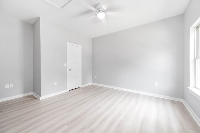 spare room featuring light wood-style floors, ceiling fan, and baseboards