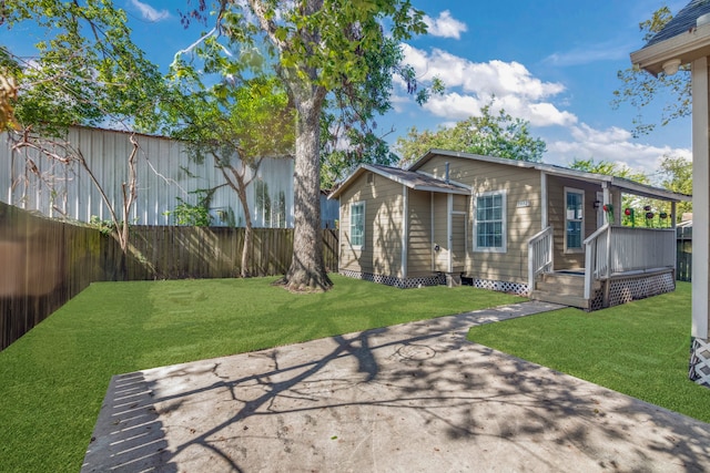 back of property with a yard and a fenced backyard