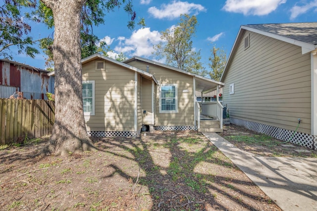 back of house with fence