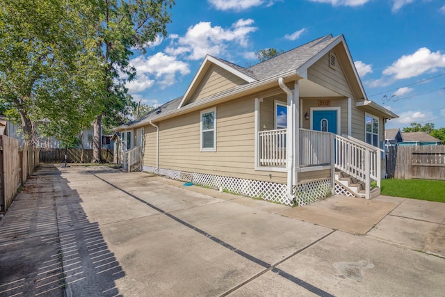 exterior space with a shingled roof and fence