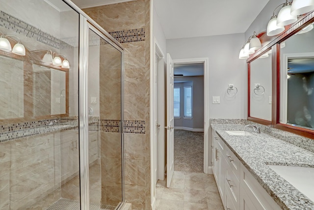 full bath featuring double vanity, a stall shower, and a sink