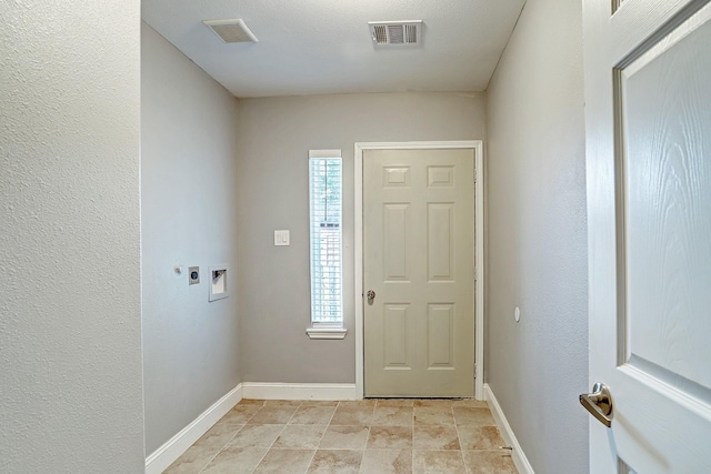 foyer entrance featuring visible vents and baseboards