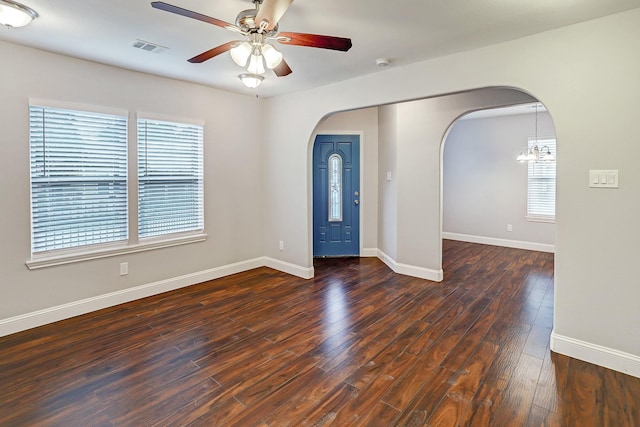 entryway featuring a ceiling fan, arched walkways, visible vents, and hardwood / wood-style flooring