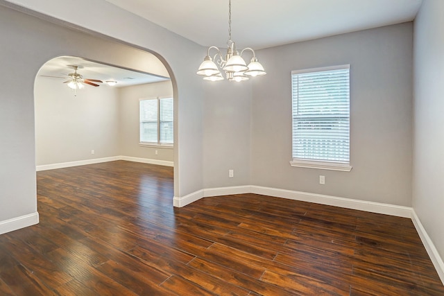 unfurnished room with dark wood-style floors, arched walkways, baseboards, and ceiling fan with notable chandelier