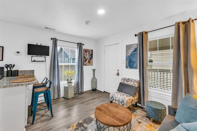 interior space featuring light wood-type flooring, visible vents, and baseboards