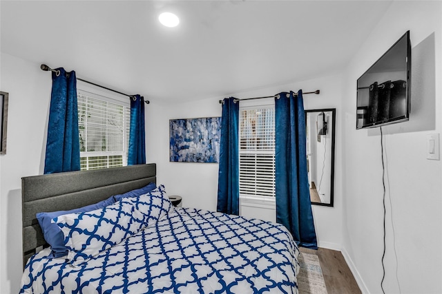 bedroom with baseboards and wood finished floors