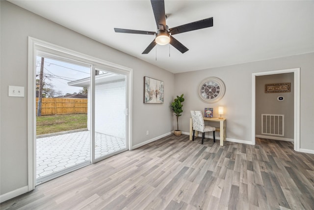 unfurnished office featuring ceiling fan, light wood-type flooring, visible vents, and baseboards