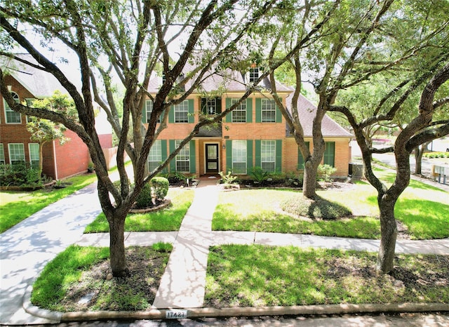 colonial-style house with brick siding