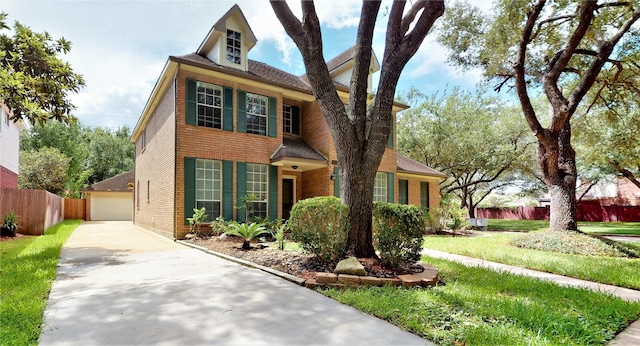 view of front of property featuring a garage, brick siding, and fence