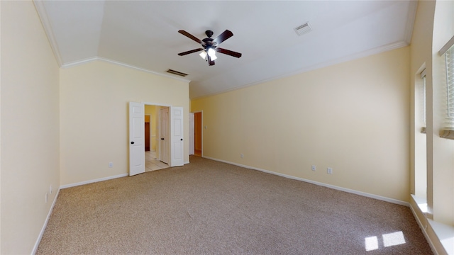 unfurnished bedroom featuring crown molding, light colored carpet, visible vents, and vaulted ceiling