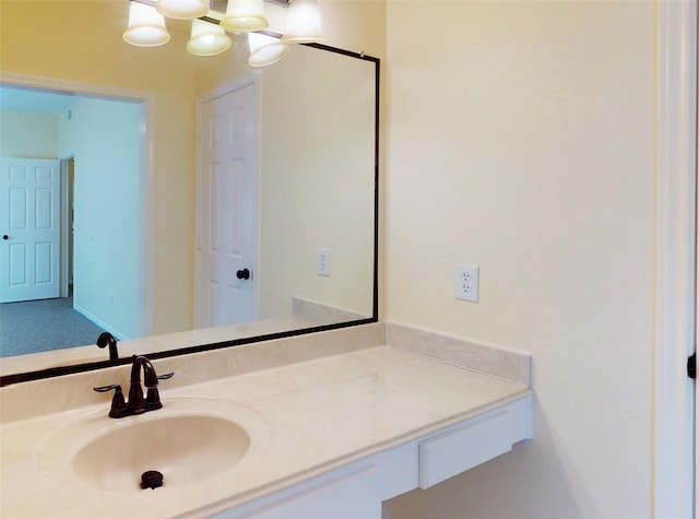 bathroom with a chandelier and vanity