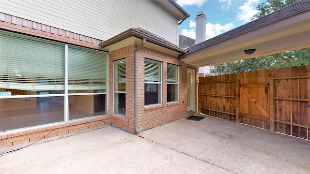 view of patio / terrace featuring a gate and fence