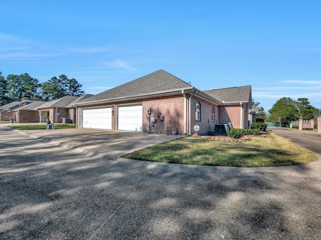 view of side of home featuring a garage, concrete driveway, brick siding, and a shingled roof