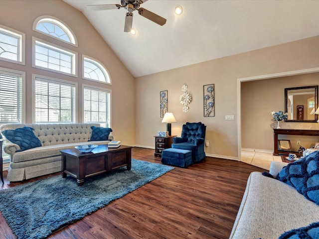 living room featuring high vaulted ceiling, a ceiling fan, baseboards, and wood finished floors