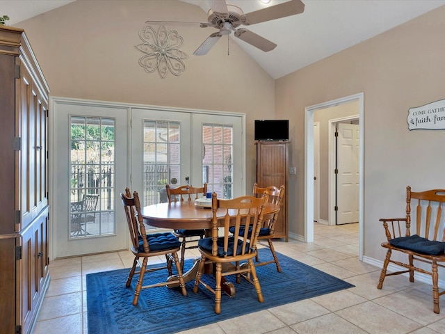 dining room with light tile patterned floors, high vaulted ceiling, ceiling fan, baseboards, and french doors