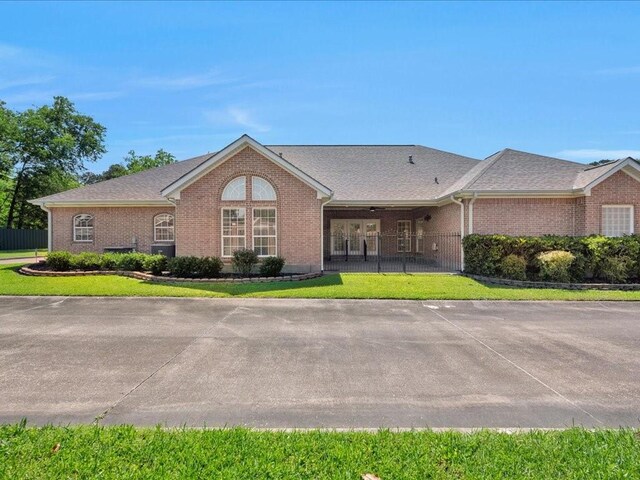 2601 Woodstock Dr, Lufkin, TX 75904 - view of front of house with brick siding and roof with shingles