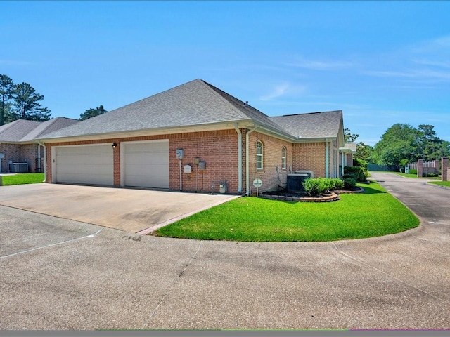 2601 Woodstock Dr, Lufkin, TX 75904 - view of home's exterior with a garage, brick siding, concrete driveway, a lawn, and a shingled roof