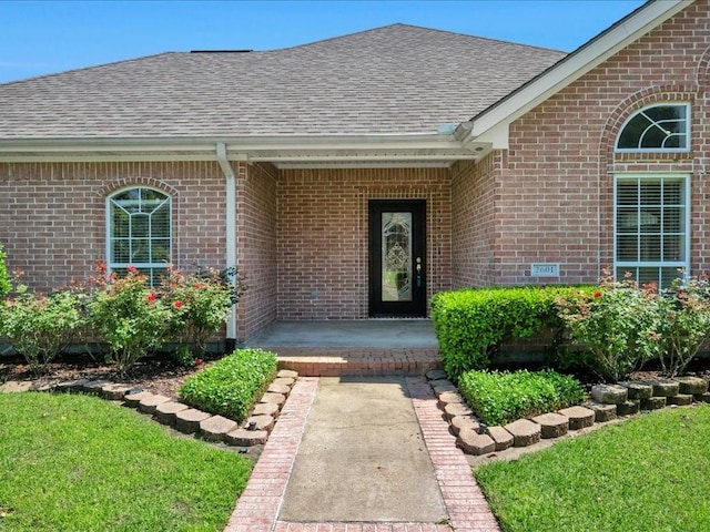 2601 Woodstock Dr, Lufkin, TX 75904 - property entrance featuring roof with shingles and brick siding