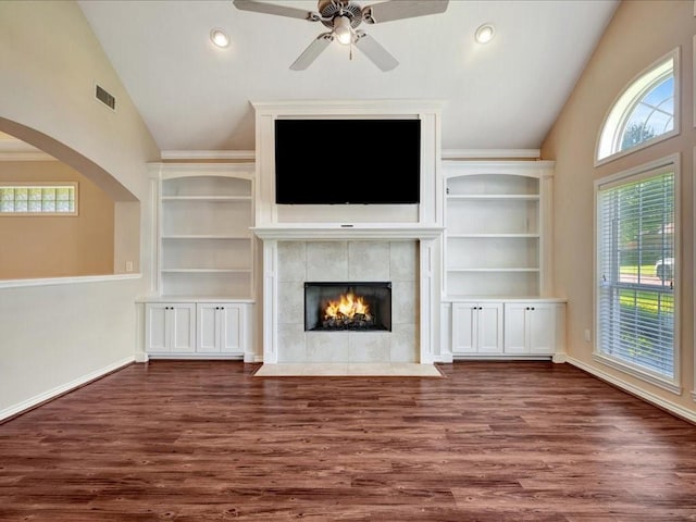 2601 Woodstock Dr, Lufkin, TX 75904 - unfurnished living room with lofted ceiling, healthy amount of natural light, wood finished floors, a tiled fireplace, and ceiling fan