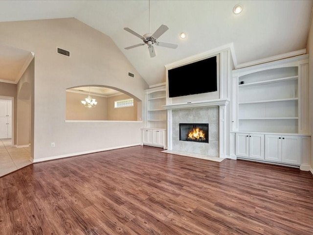 2601 Woodstock Dr, Lufkin, TX 75904 - unfurnished living room with a fireplace, wood finished floors, a ceiling fan, baseboards, and high vaulted ceiling