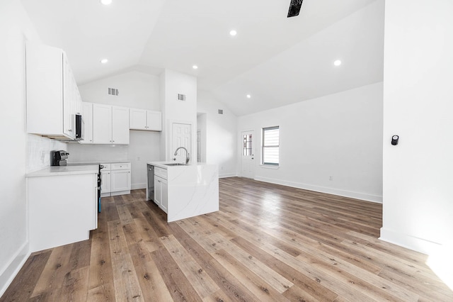 kitchen featuring light wood-type flooring, visible vents, stainless steel appliances, and a sink