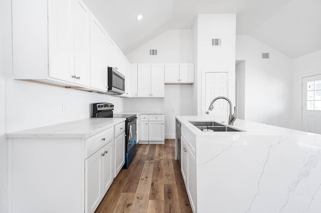 kitchen featuring appliances with stainless steel finishes, a sink, visible vents, and white cabinets