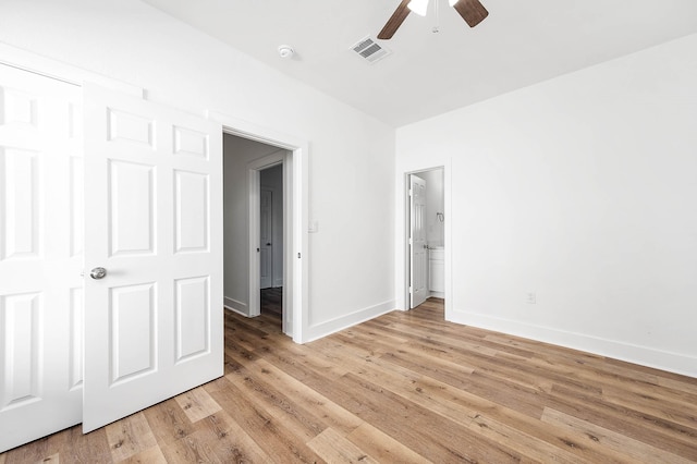 empty room with baseboards, ceiling fan, visible vents, and light wood-style floors