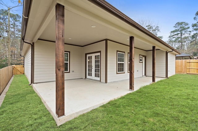 back of property featuring a patio area, a fenced backyard, a lawn, and french doors