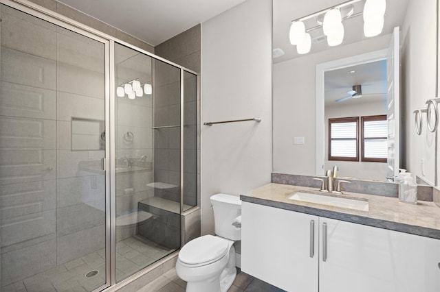 full bathroom featuring tile patterned flooring, a shower stall, toilet, and vanity