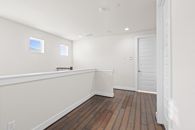 unfurnished room featuring dark wood-type flooring, recessed lighting, visible vents, and baseboards