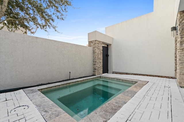 view of swimming pool with an in ground hot tub