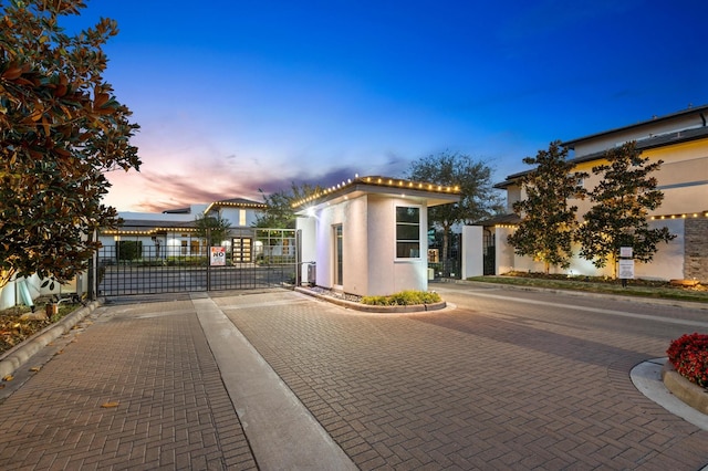 view of front of property featuring a gate and stucco siding