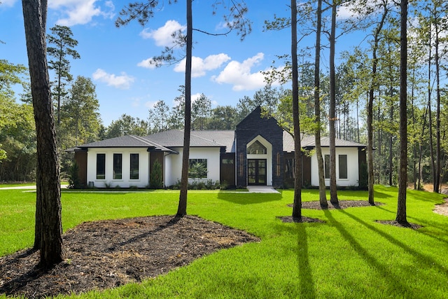 view of front of home featuring a front lawn and french doors