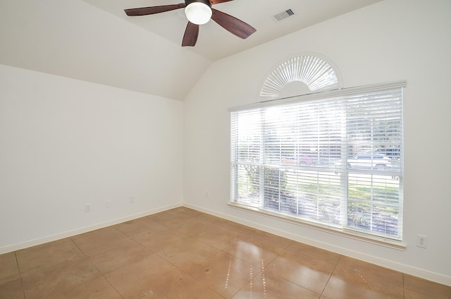 unfurnished room featuring baseboards, visible vents, vaulted ceiling, and a ceiling fan