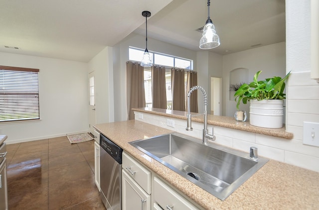 kitchen with a sink, white cabinets, light countertops, and dishwasher