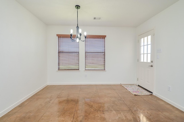 unfurnished dining area featuring visible vents, a notable chandelier, and baseboards