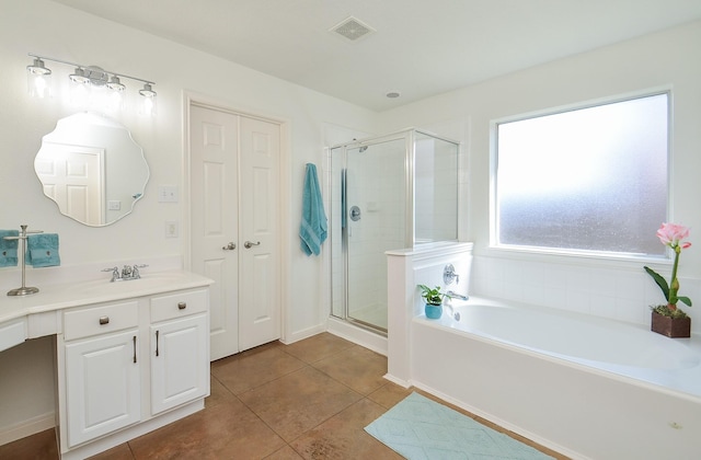 bathroom featuring a bath, a stall shower, tile patterned flooring, and visible vents