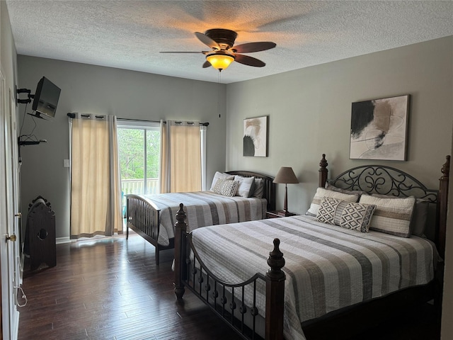 bedroom featuring a textured ceiling, ceiling fan, dark wood-type flooring, and access to outside