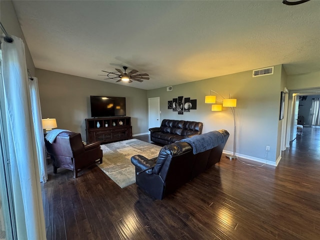 living room featuring a ceiling fan, baseboards, visible vents, and wood finished floors